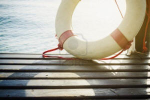 Safety Element - Life Preserver on wood floor, sea as background Stock Photo - 13459845
